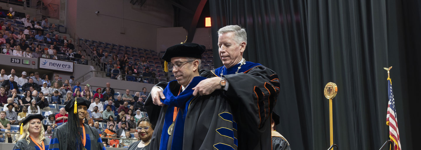 Ph.D. student receiving their hood